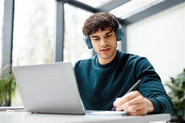 Ein junger Mann arbeitet mit Laptop